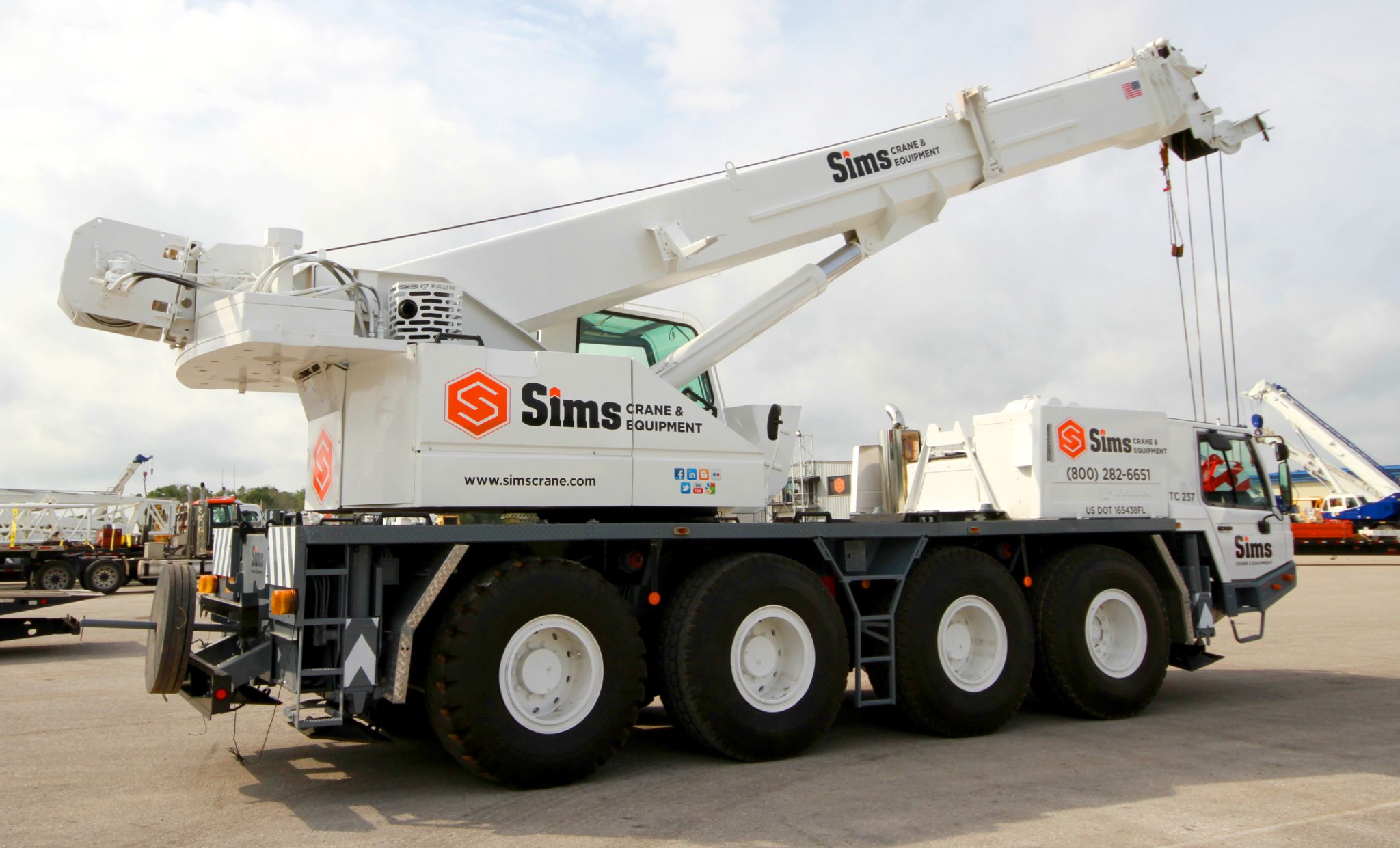 Professional crane operator demonstrating All Terrain Crane Operations techniques on an active construction site - essential knowledge for NCCCO certification exam preparation covering all terrain crane safety protocols and operational procedures
