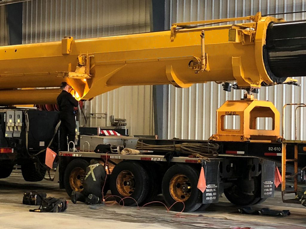 Crane operator performing boom inspection procedures during pre-shift inspection - critical skills tested on NCCCO written and practical exams for LAT and TSS certification