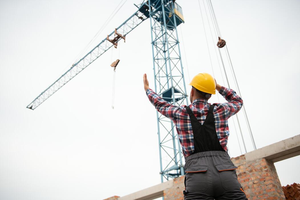 Complete overview of Essential Tools and Gear for Crane Operators featuring certified crane operator executing lift plan with proper hand signals, ground crew coordination, and safety zone establishment per OSHA regulations