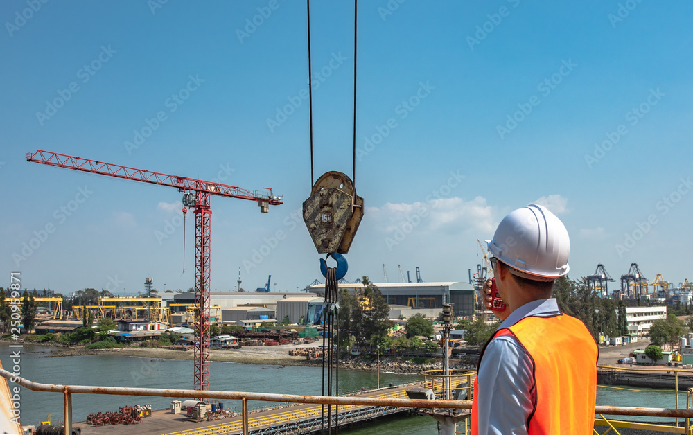 Professional crane operator demonstrating From Crane Operator to Crane Supervisor techniques on an active construction site - essential knowledge for NCCCO certification exam preparation covering crane supervisor safety protocols and operational procedures