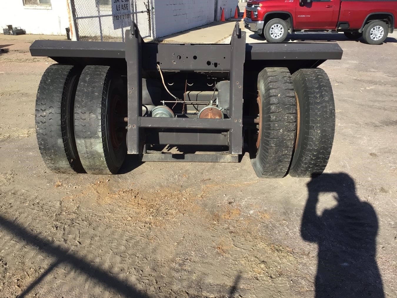 Complete overview of Crane Boom Dolly Transport and Assembly featuring certified crane operator executing lift plan with proper hand signals, ground crew coordination, and safety zone establishment per OSHA regulations