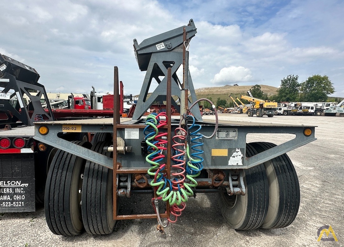 Professional crane operator demonstrating Crane Boom Dolly Transport and Assembly techniques on an active construction site - essential knowledge for NCCCO certification exam preparation covering boom dolly crane safety protocols and operational procedures
