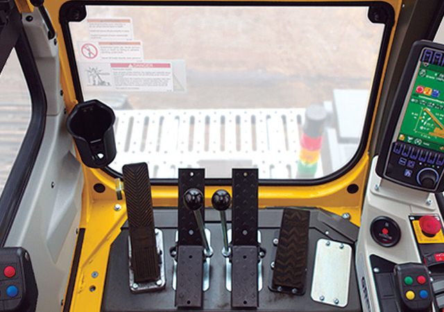 Professional crane operator demonstrating Crane Cab Controls Layout and Ergonomics techniques on an active construction site - essential knowledge for NCCCO certification exam preparation covering crane cab controls safety protocols and operational procedures