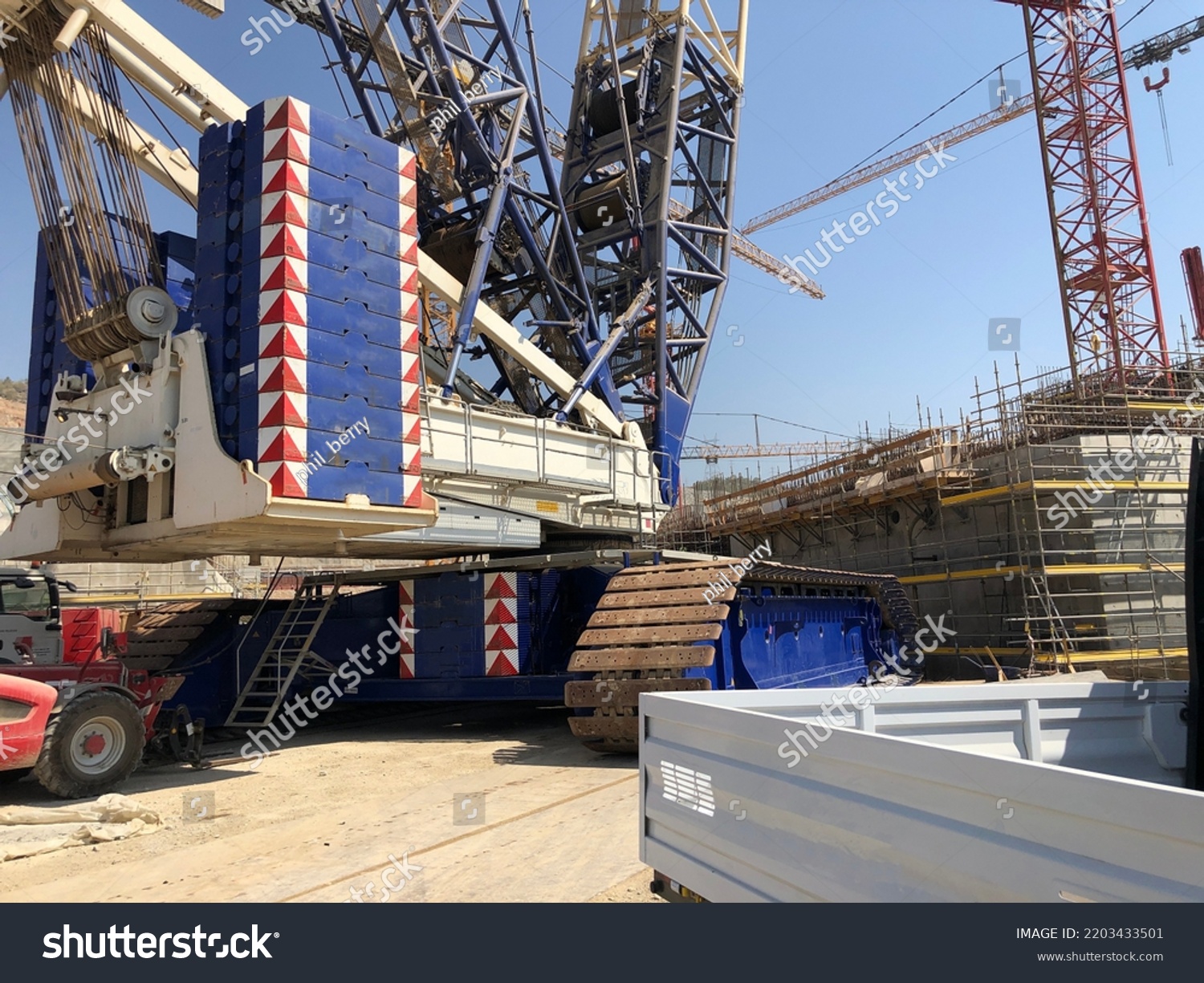 Complete overview of Crane Counterweight Calculations featuring certified crane operator executing lift plan with proper hand signals, ground crew coordination, and safety zone establishment per OSHA regulations