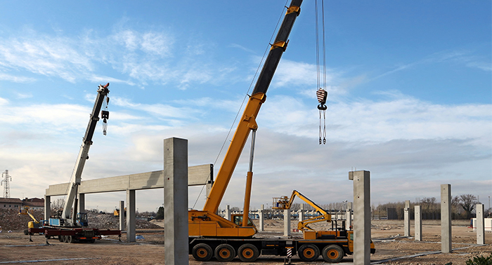Professional crane operator demonstrating Crane Lubrication Guide techniques on an active construction site - essential knowledge for NCCCO certification exam preparation covering crane lubrication safety protocols and operational procedures