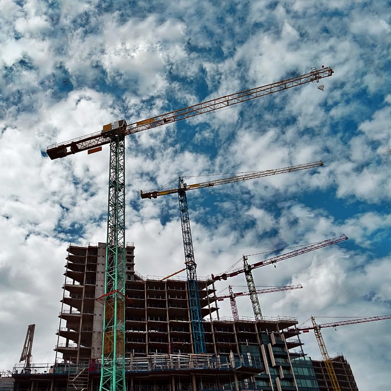Professional crane operator demonstrating Crane Operator Apprenticeship Guide techniques on an active construction site - essential knowledge for NCCCO certification exam preparation covering crane apprenticeship safety protocols and operational procedures