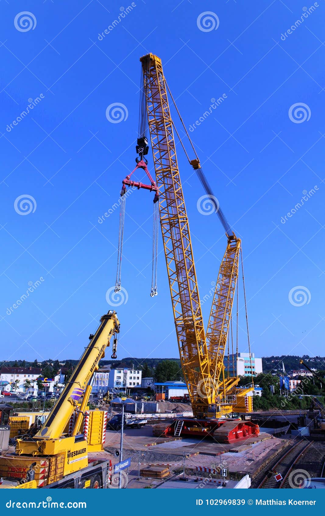 Professional crane operator demonstrating Telescopic Boom vs Lattice Boom Cranes techniques on an active construction site - essential knowledge for NCCCO certification exam preparation covering telescopic vs lattice safety protocols and operational procedures