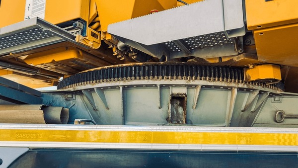 Professional crane operator demonstrating Crane Turntable and Swing Bearing Inspection techniques on an active construction site - essential knowledge for NCCCO certification exam preparation covering turntable inspection crane safety protocols and operational procedures
