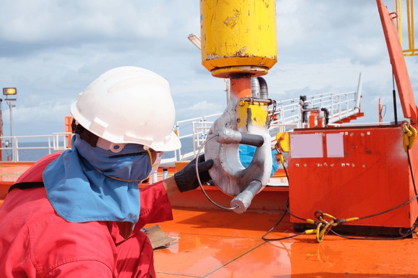 Professional crane operator demonstrating Crane Structural Crack Detection Methods techniques on an active construction site - essential knowledge for NCCCO certification exam preparation covering crane crack detection safety protocols and operational procedures