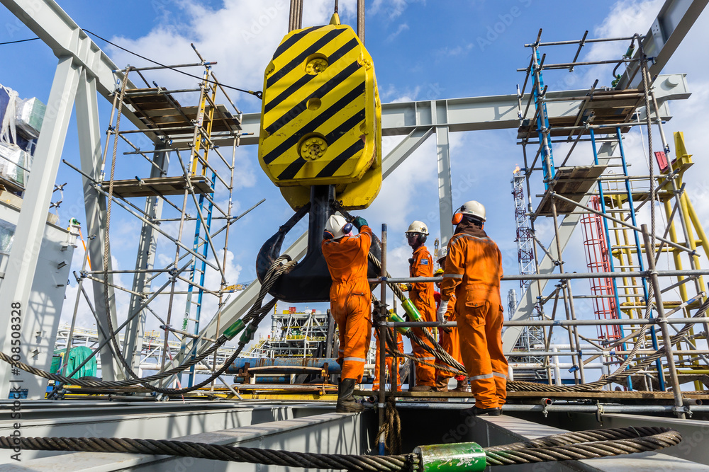 Crane operator performing outrigger inspection procedures during pre-shift inspection - critical skills tested on NCCCO written and practical exams for LAT and TSS certification