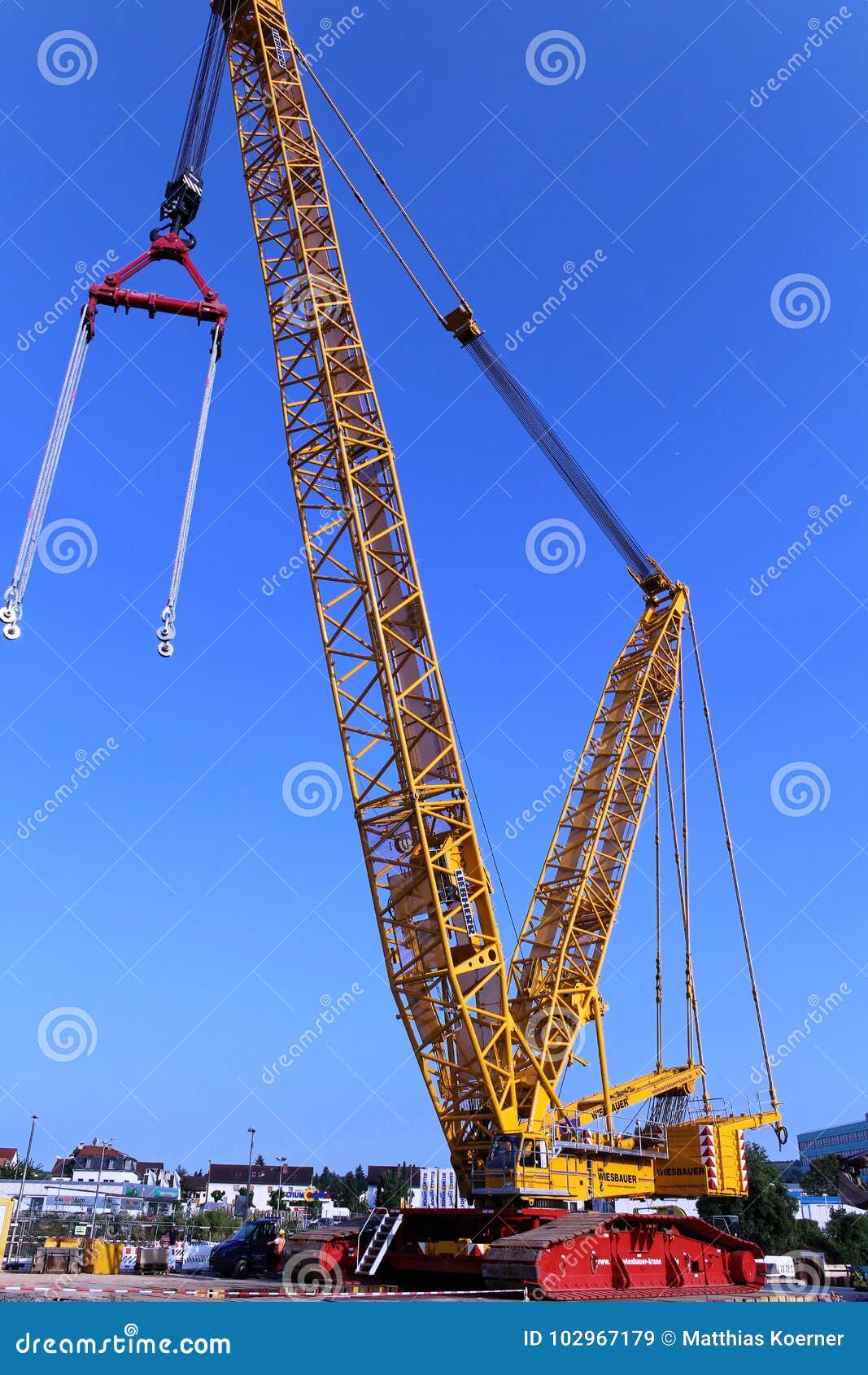 Complete overview of Lattice Boom Crane Load Charts featuring certified crane operator executing lift plan with proper hand signals, ground crew coordination, and safety zone establishment per OSHA regulations