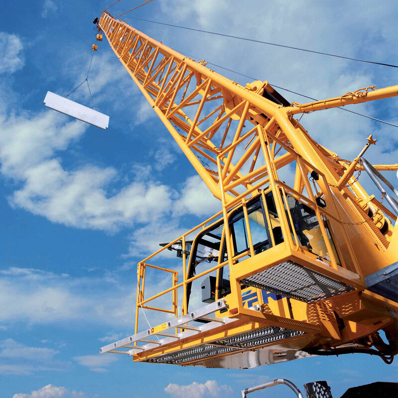 Professional crane operator demonstrating Lattice Boom Crane Load Charts techniques on an active construction site - essential knowledge for NCCCO certification exam preparation covering lattice boom load chart safety protocols and operational procedures