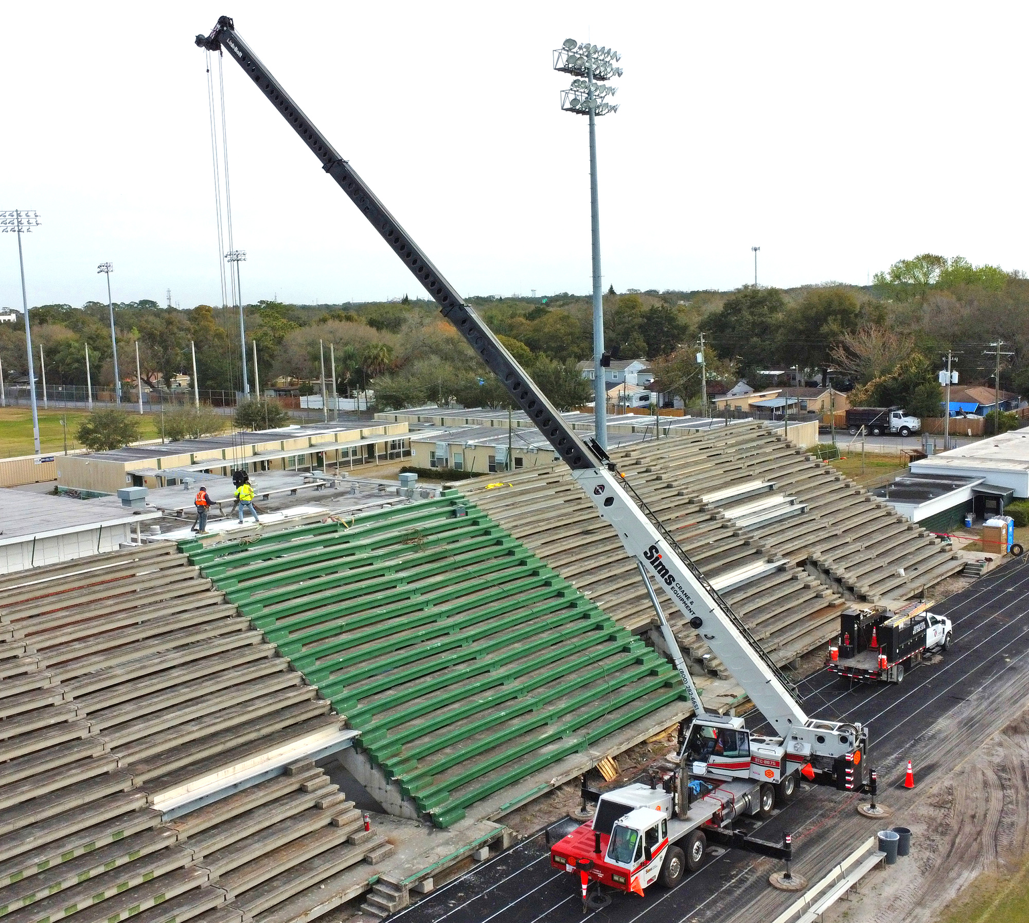 Professional crane operator demonstrating Link-Belt Crane Models for NCCCO Operators techniques on an active construction site - essential knowledge for NCCCO certification exam preparation covering link belt crane safety protocols and operational procedures