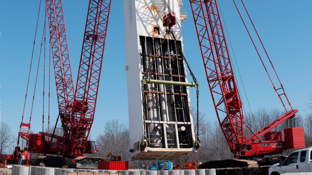 Complete overview of Why Crane Level Matters for Load Chart Accuracy featuring certified crane operator executing lift plan with proper hand signals, ground crew coordination, and safety zone establishment per OSHA regulations