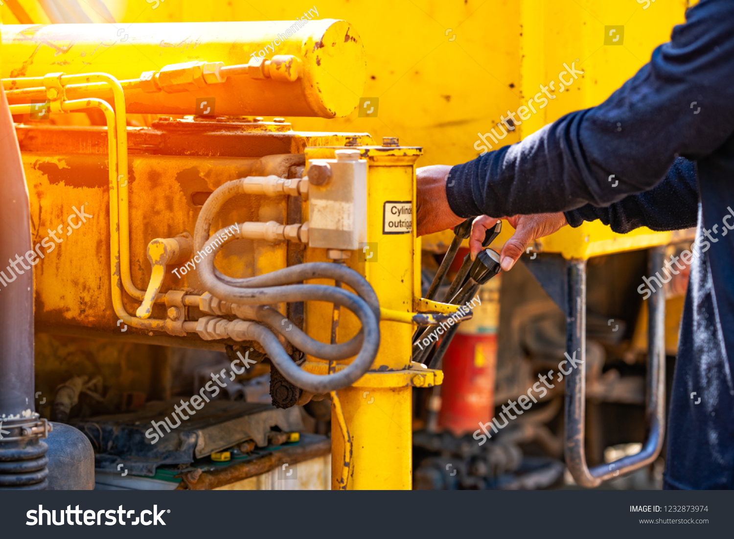 Crane operator performing outrigger configuration load chart procedures during pre-shift inspection - critical skills tested on NCCCO written and practical exams for LAT and TSS certification