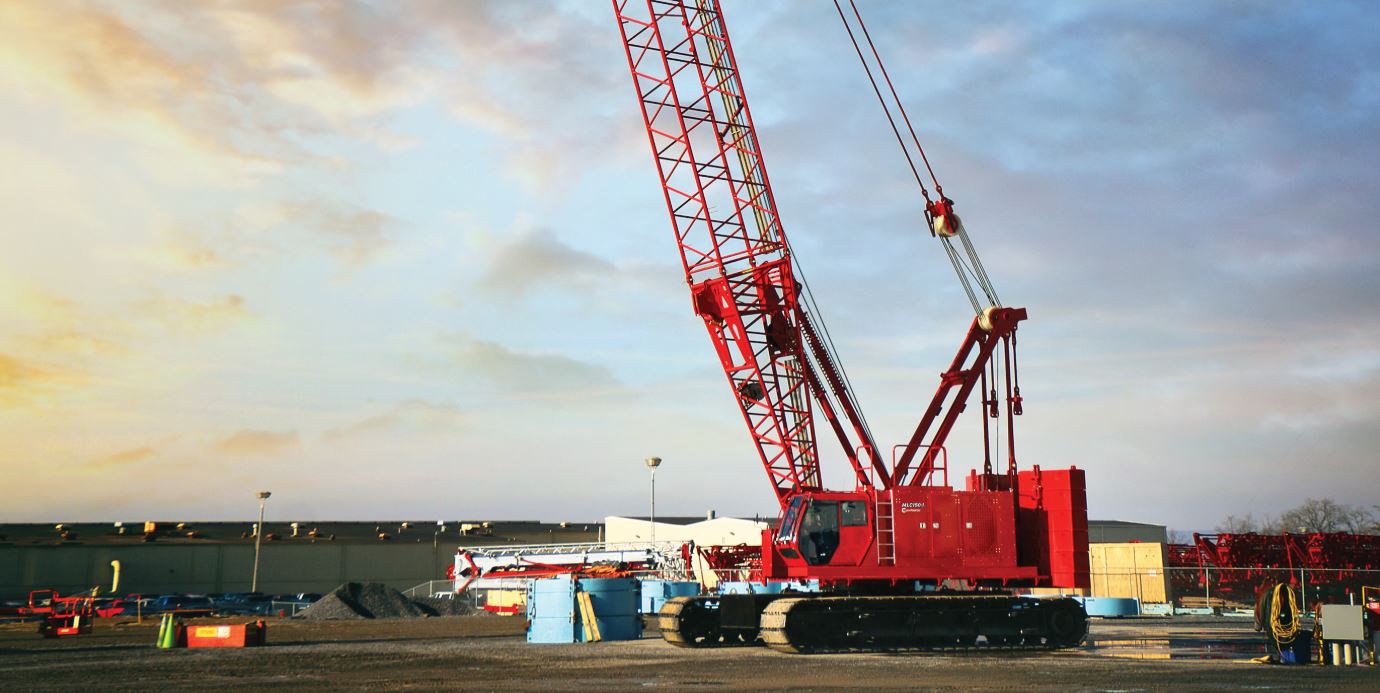Professional crane operator demonstrating Manitowoc Crawler Crane Operation Guide techniques on an active construction site - essential knowledge for NCCCO certification exam preparation covering manitowoc crane safety protocols and operational procedures