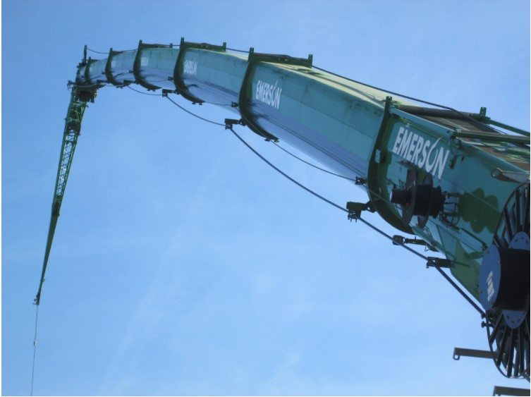 Professional crane operator demonstrating Understanding Crane Boom Deflection techniques on an active construction site - essential knowledge for NCCCO certification exam preparation covering boom deflection crane safety protocols and operational procedures