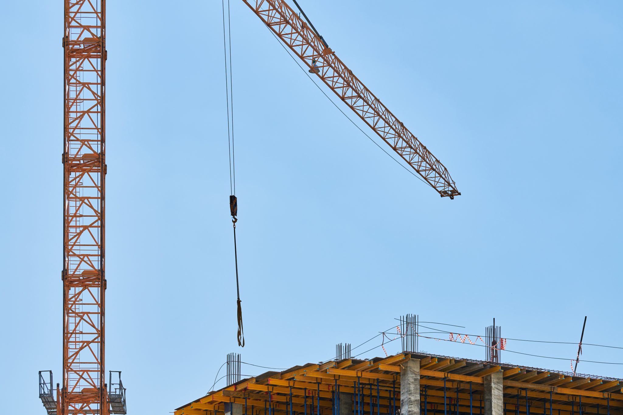 Complete overview of Wind Load Calculations for Crane Operations featuring certified crane operator executing lift plan with proper hand signals, ground crew coordination, and safety zone establishment per OSHA regulations
