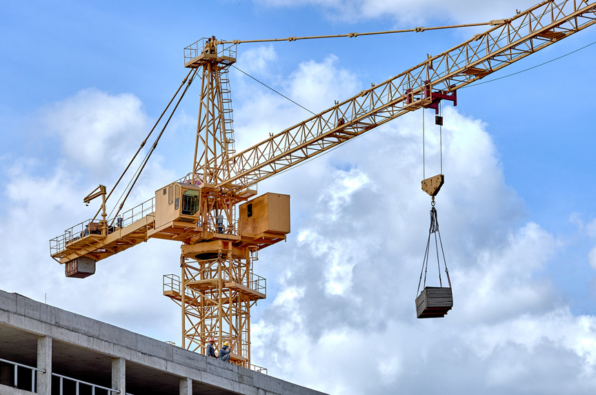 Professional crane operator demonstrating Wind Load Calculations for Crane Operations techniques on an active construction site - essential knowledge for NCCCO certification exam preparation covering wind load crane calculation safety protocols and operational procedures