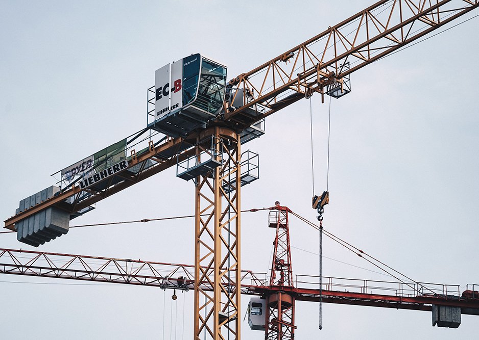 Crane operator performing wind load crane calculation procedures during pre-shift inspection - critical skills tested on NCCCO written and practical exams for LAT and TSS certification