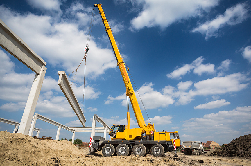 Crane operator performing mobile crane load chart procedures during pre-shift inspection - critical skills tested on NCCCO written and practical exams for LAT and TSS certification