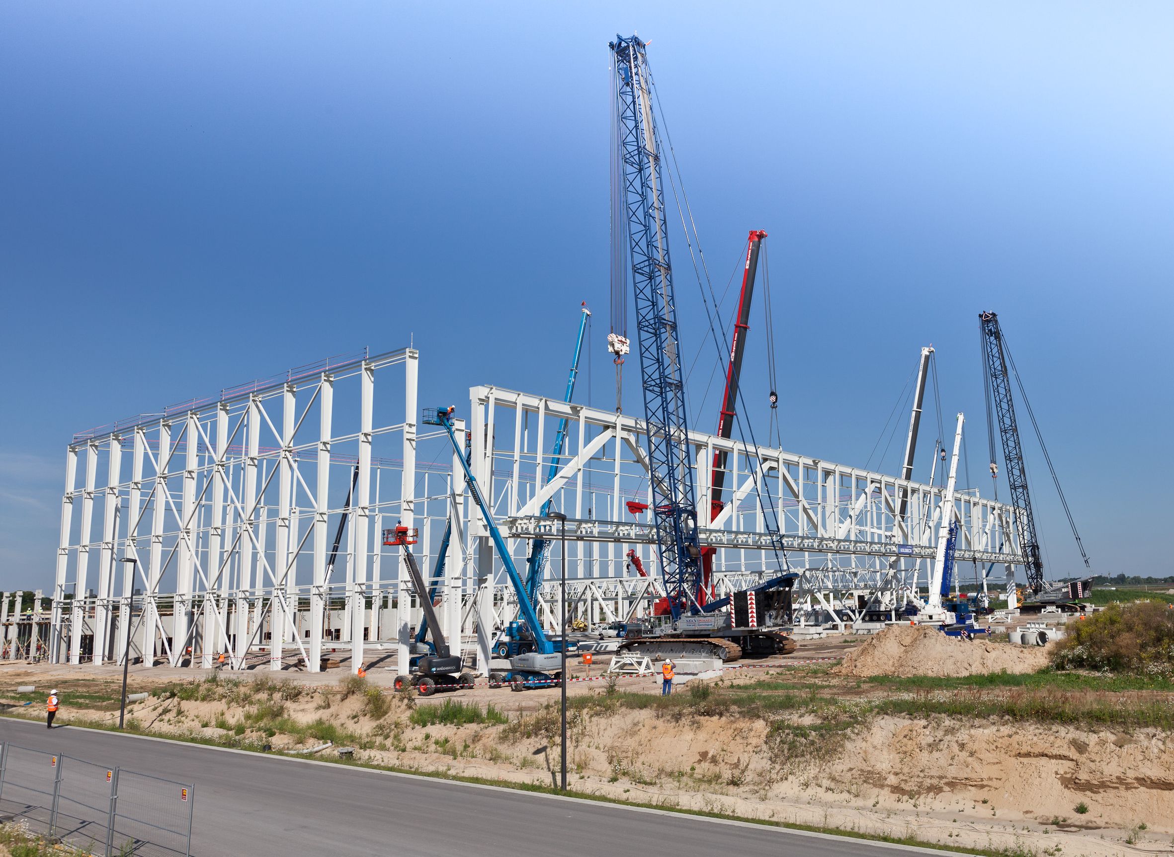 Professional crane operator demonstrating Multi-Crane Lift Procedures techniques on an active construction site - essential knowledge for NCCCO certification exam preparation covering multi crane lift safety protocols and operational procedures