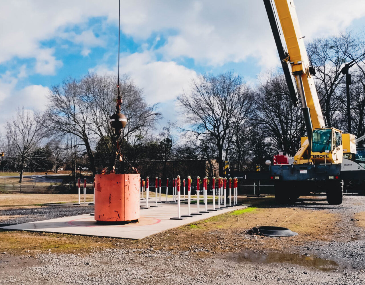 Complete overview of NCCCO Recertification Guide featuring certified crane operator executing lift plan with proper hand signals, ground crew coordination, and safety zone establishment per OSHA regulations