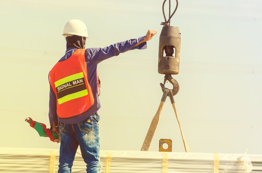 Complete overview of NCCCO Signalperson Certification Guide featuring certified crane operator executing lift plan with proper hand signals, ground crew coordination, and safety zone establishment per OSHA regulations