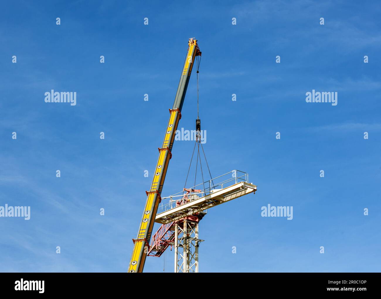 Complete overview of OSHA Assembly Disassembly Director Requirements featuring certified crane operator executing lift plan with proper hand signals, ground crew coordination, and safety zone establishment per OSHA regulations