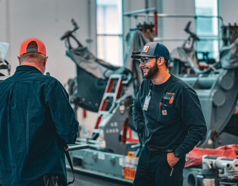 Complete overview of OSHA Competent Person Requirements for Cranes featuring certified crane operator executing lift plan with proper hand signals, ground crew coordination, and safety zone establishment per OSHA regulations