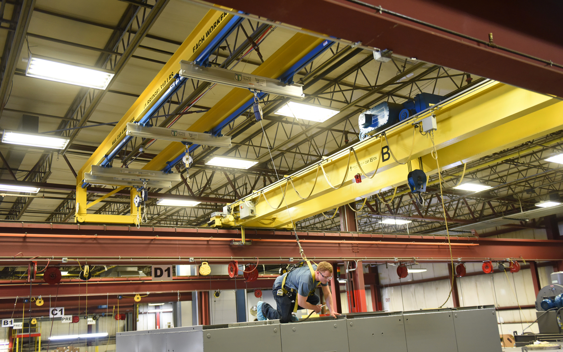 Complete overview of OSHA Fall Protection Requirements on Cranes featuring certified crane operator executing lift plan with proper hand signals, ground crew coordination, and safety zone establishment per OSHA regulations