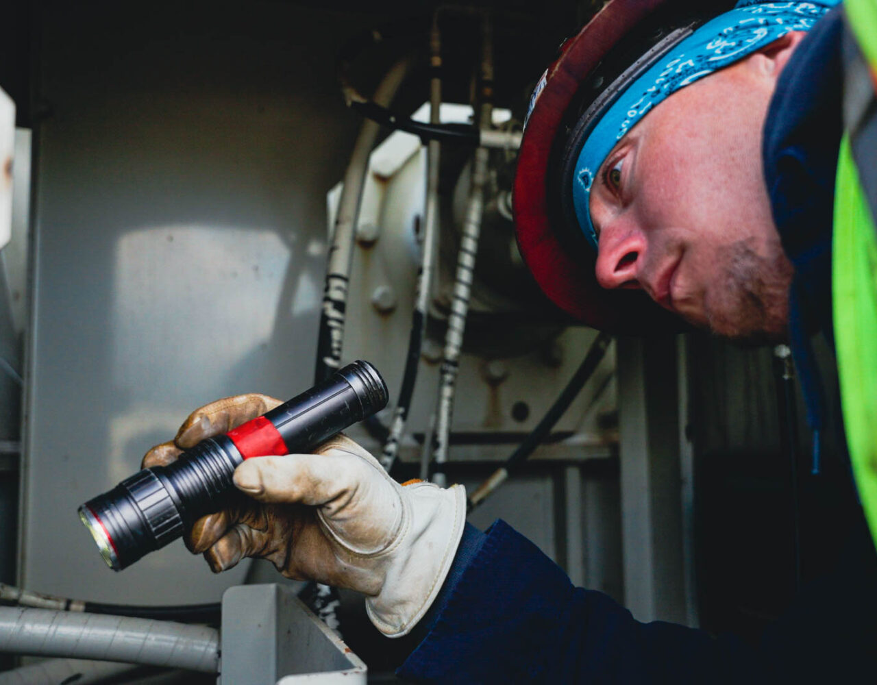 Complete overview of OSHA Crane Inspection Frequency Requirements featuring certified crane operator executing lift plan with proper hand signals, ground crew coordination, and safety zone establishment per OSHA regulations