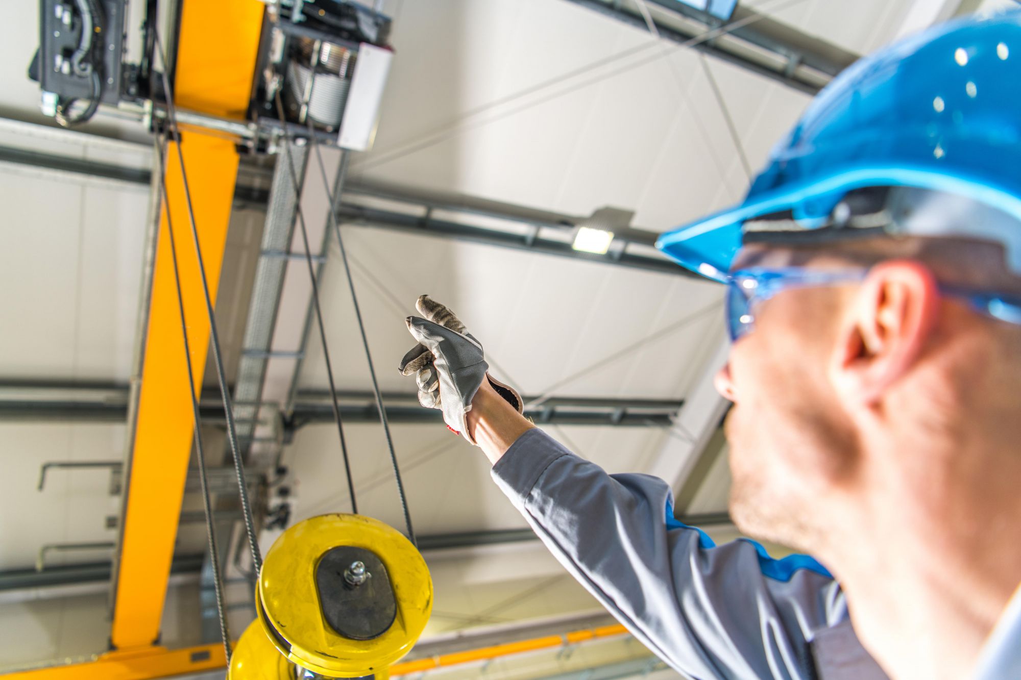 Complete overview of OSHA Crane Inspection Requirements featuring certified crane operator executing lift plan with proper hand signals, ground crew coordination, and safety zone establishment per OSHA regulations