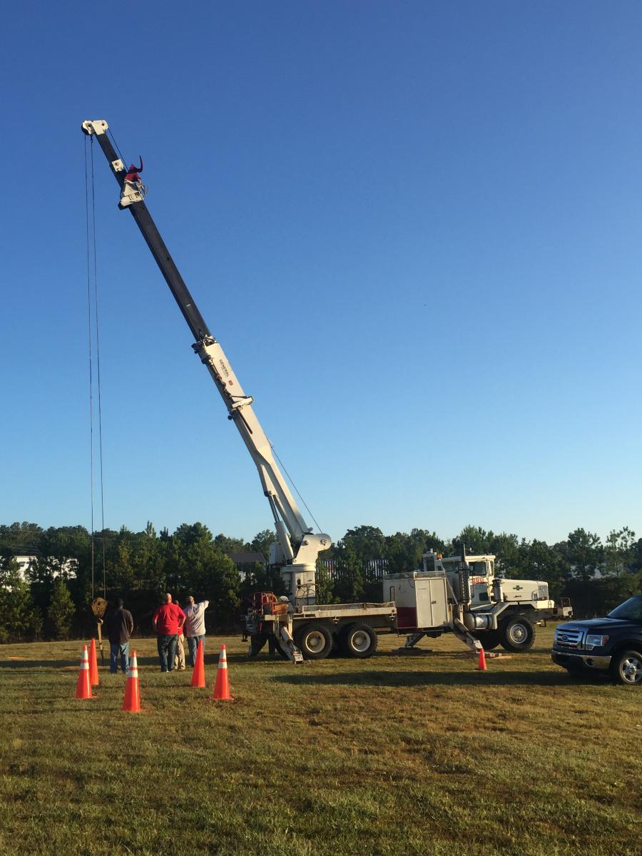 Step-by-step demonstration of OSHA Crane Operator Qualification Requirements showing load chart interpretation, boom angle calculations, and outrigger positioning per NCCCO certification requirements and ASME standards