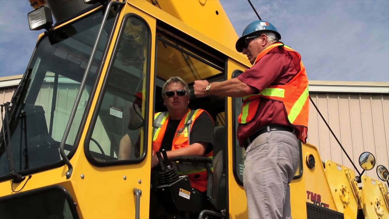 Professional crane operator demonstrating OSHA Crane Operator Qualification Requirements techniques on an active construction site - essential knowledge for NCCCO certification exam preparation covering osha operator qualification safety protocols and operational procedures