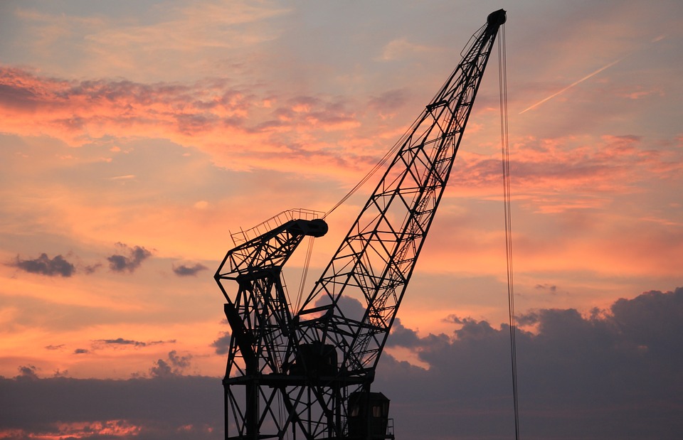 Complete overview of OSHA Crane Weather Shutdown Requirements featuring certified crane operator executing lift plan with proper hand signals, ground crew coordination, and safety zone establishment per OSHA regulations