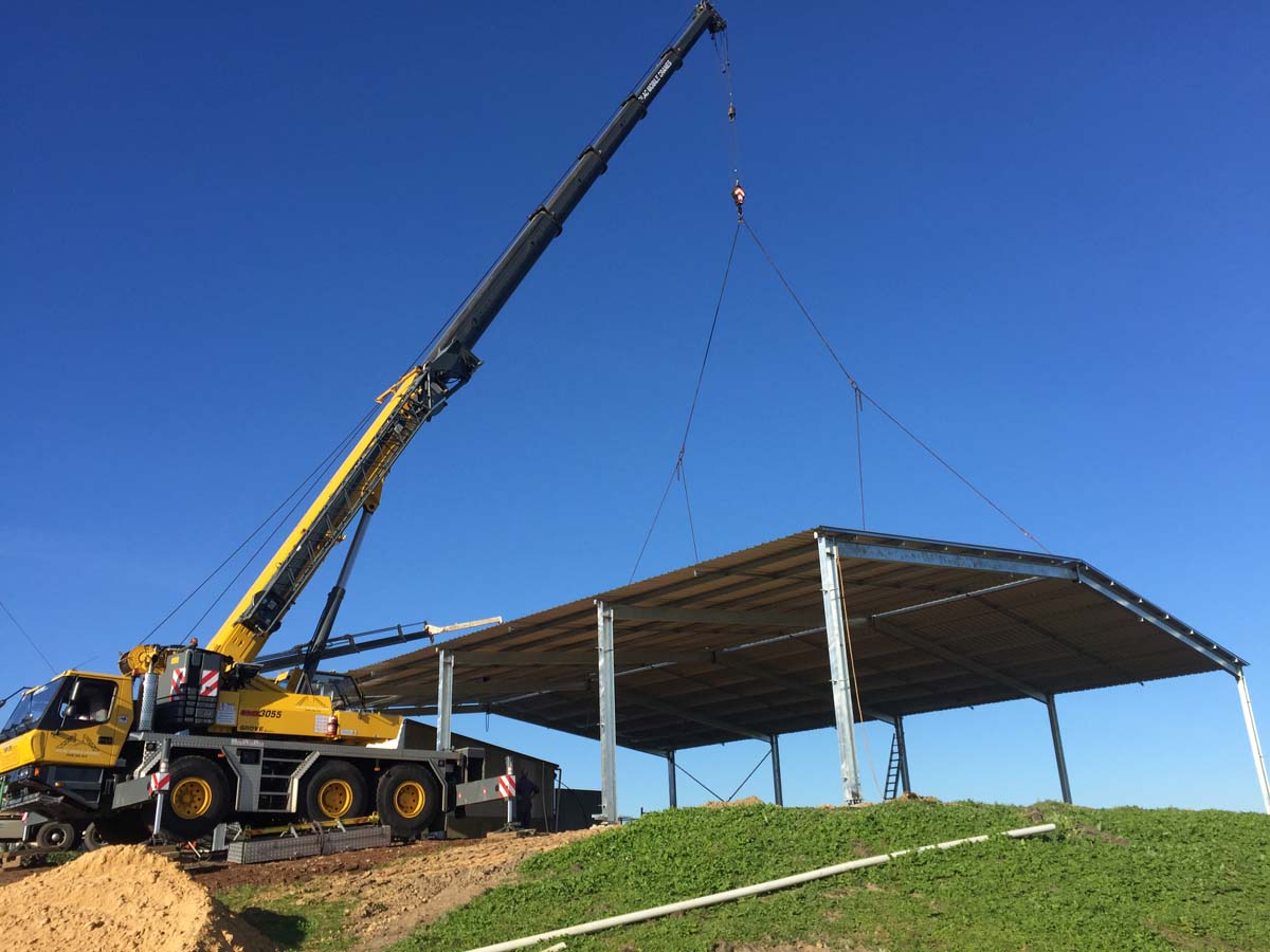 Complete overview of OSHA Multi-Employer Worksite Crane Rules featuring certified crane operator executing lift plan with proper hand signals, ground crew coordination, and safety zone establishment per OSHA regulations