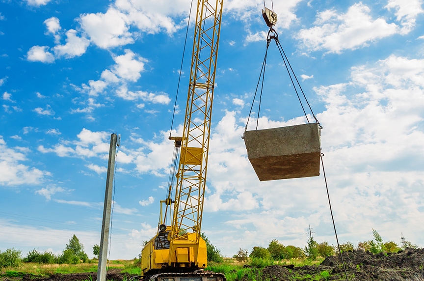 Crane operator performing tagline crane procedures during pre-shift inspection - critical skills tested on NCCCO written and practical exams for LAT and TSS certification