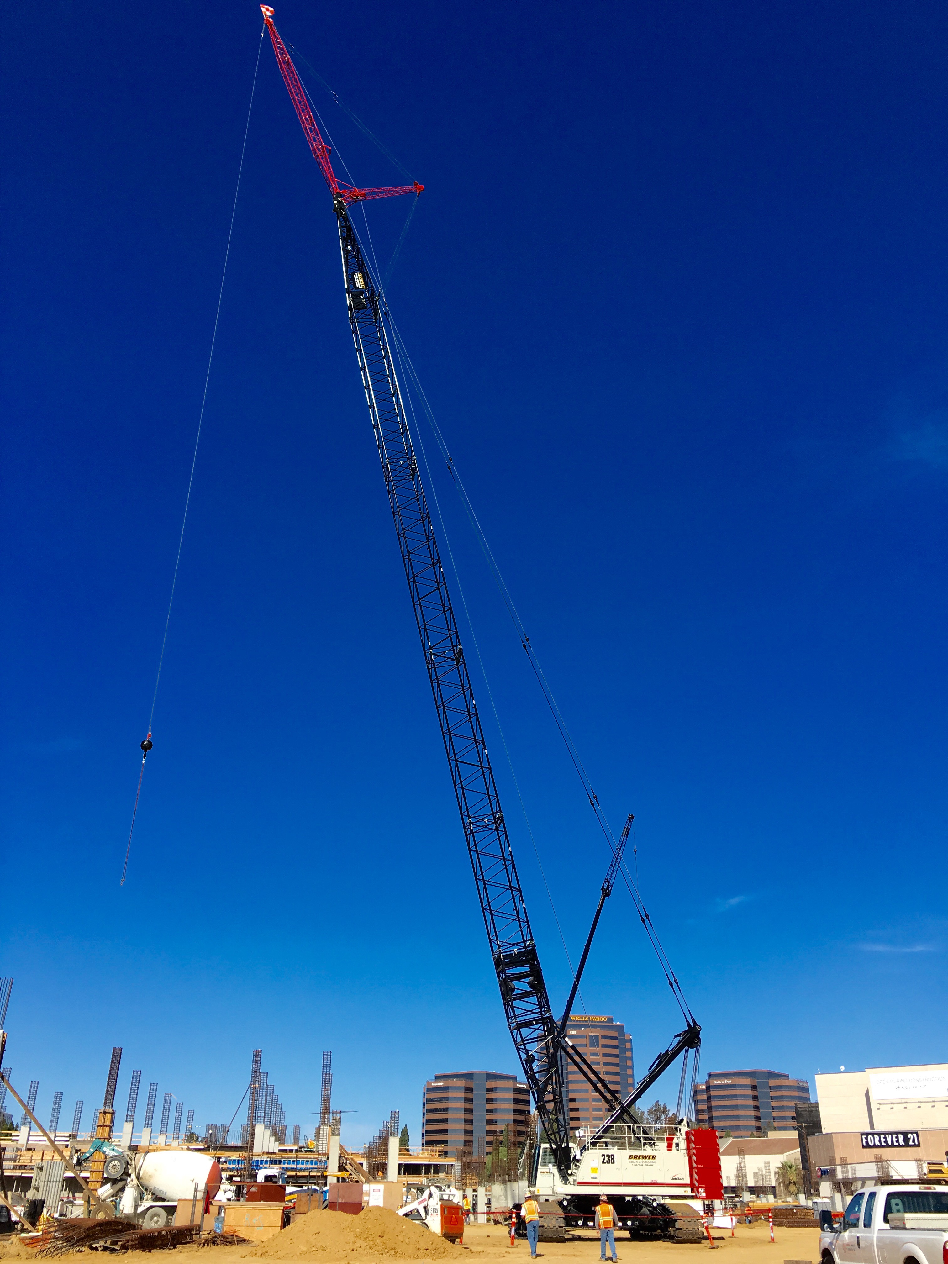 Complete overview of Rough Terrain Crane Guide featuring certified crane operator executing lift plan with proper hand signals, ground crew coordination, and safety zone establishment per OSHA regulations