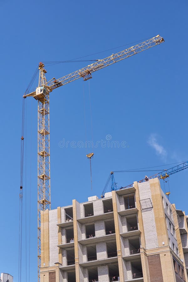Crane operator performing crane near building procedures during pre-shift inspection - critical skills tested on NCCCO written and practical exams for LAT and TSS certification