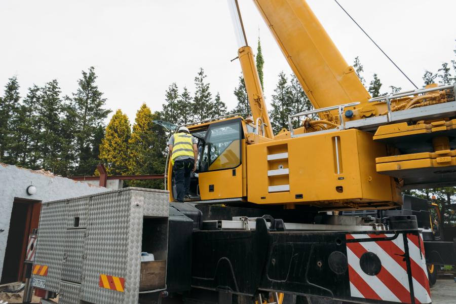 Complete overview of Crane Operator Fatigue Management featuring certified crane operator executing lift plan with proper hand signals, ground crew coordination, and safety zone establishment per OSHA regulations