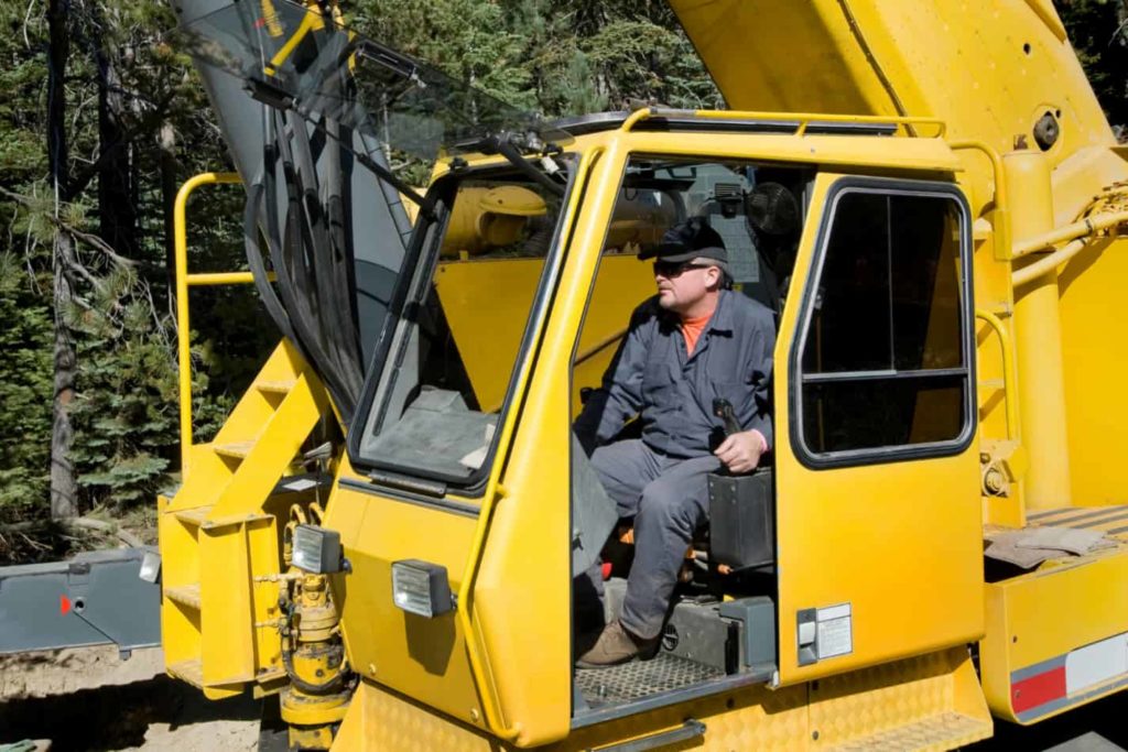Professional crane operator demonstrating Crane Operator Fatigue Management techniques on an active construction site - essential knowledge for NCCCO certification exam preparation covering operator fatigue crane safety protocols and operational procedures
