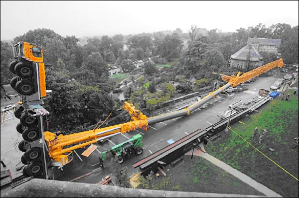 Professional crane operator demonstrating Crane Tip Over Prevention and Warning Signs techniques on an active construction site - essential knowledge for NCCCO certification exam preparation covering crane tip over safety protocols and operational procedures
