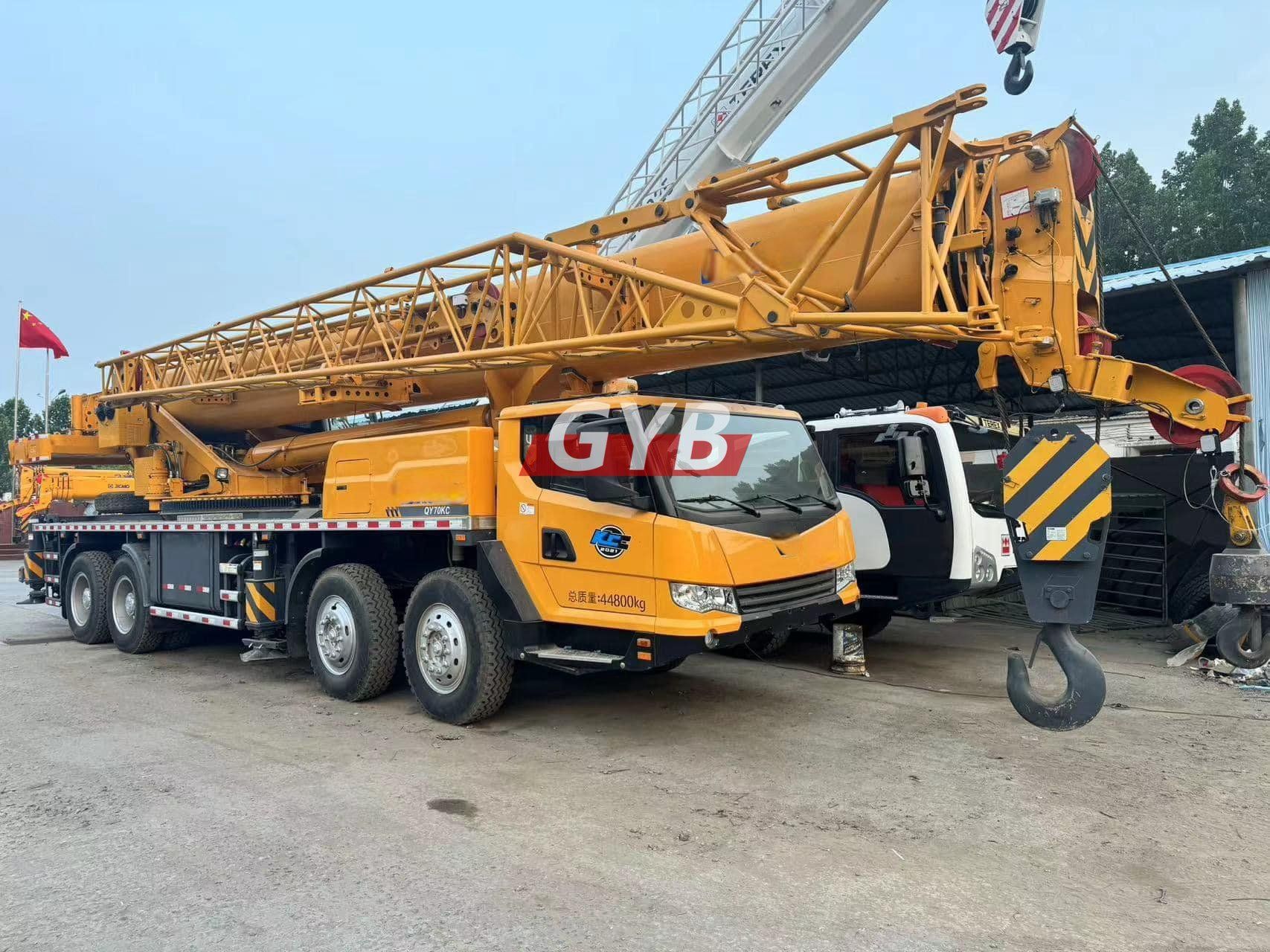 Complete overview of Electric Crane Technology and the Industry Future featuring certified crane operator executing lift plan with proper hand signals, ground crew coordination, and safety zone establishment per OSHA regulations